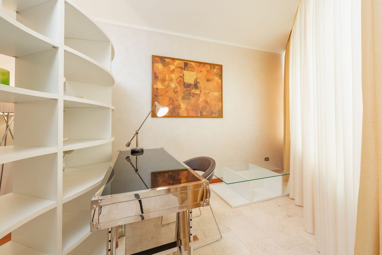 A home office desk with an ergonomic chair in daylight