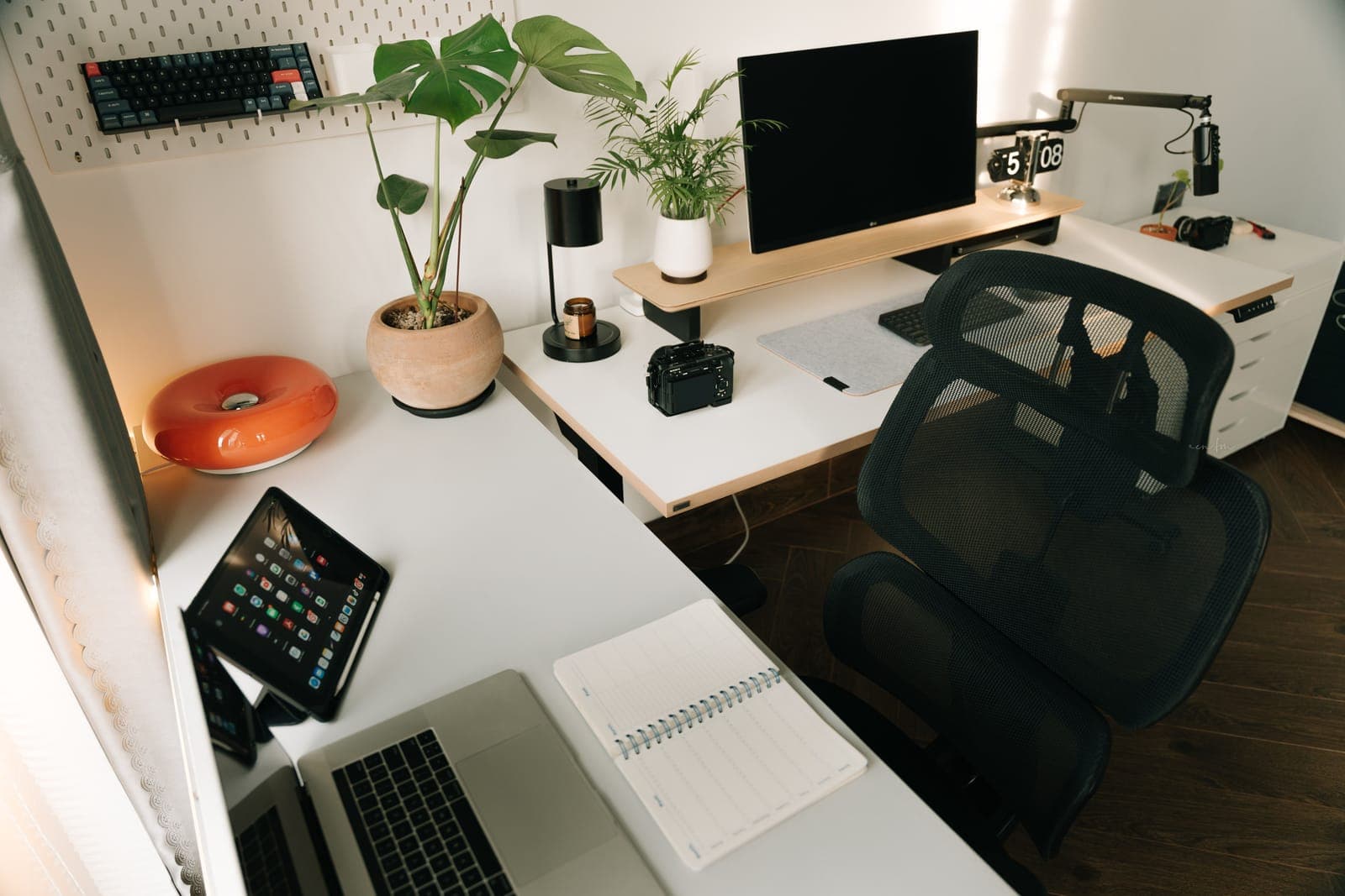 Gray mesh ergonomic office chair with a headrest in a home workspace